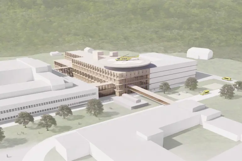 Sykehuset med en ny, stor helikopterlandingsplass og nytt aktuttbygg på området- Illustrasjon.